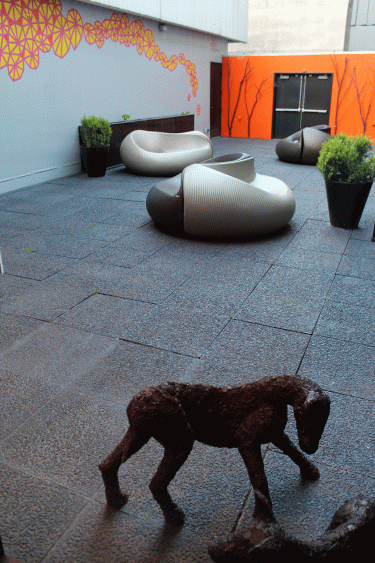 Bronze works by Engel seen in the foreground here, on a hotel patio, with mural by Molly Rose Freeman in the background.